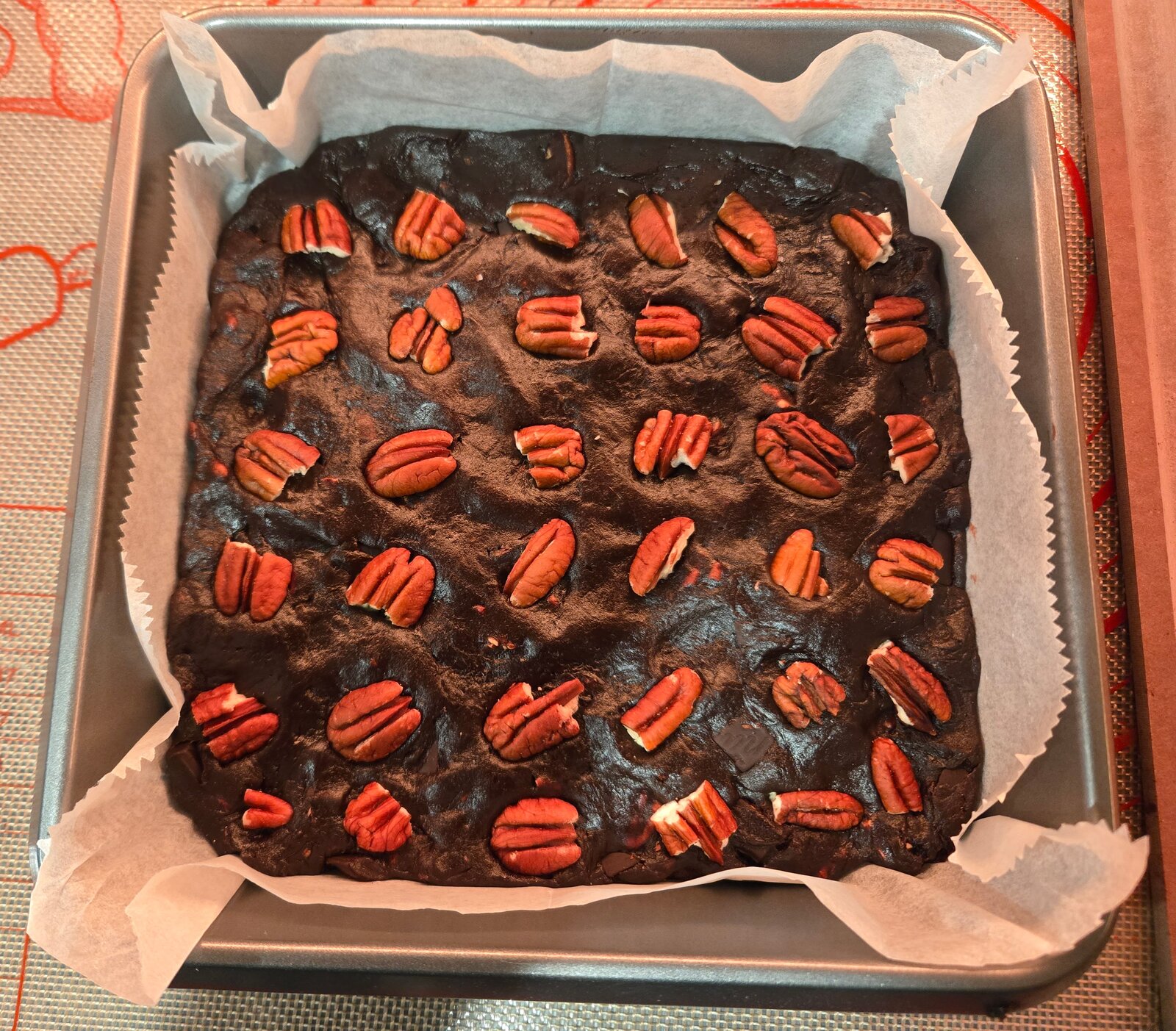 Dates brownies topped with pecans before baking